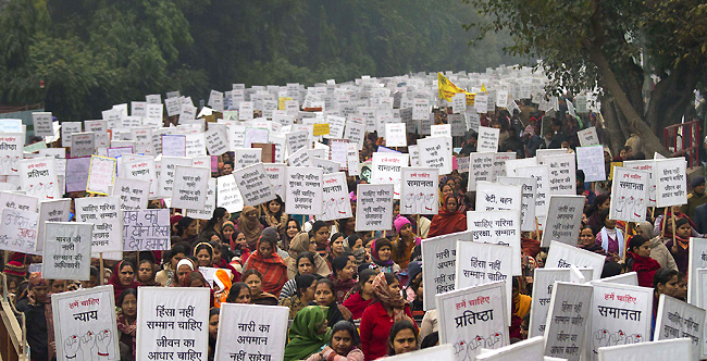Indian women carry placards as they march to mourn the death of a gang rape victim in New Delhi, India, Wednesday, Jan. 2, 2013. India's top court says it will decide whether to suspend lawmakers facing sexual assault charges as thousands of women gathered at the memorial to independence leader Mohandas K. Gandhi to demand stronger protection for their safety. The banners read "India won't tolerate women's insult and We want respect not violence in life." (AP Photo/ Dar Yasin)